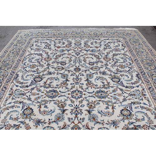 22 - Tabriz carpet of all-over floral design, with multiple borders, on a beige ground, 414cm x 286cm