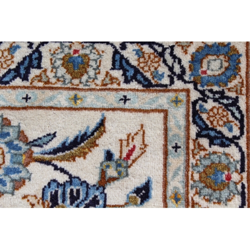 22 - Tabriz carpet of all-over floral design, with multiple borders, on a beige ground, 414cm x 286cm
