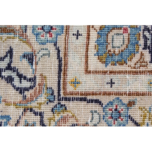 22 - Tabriz carpet of all-over floral design, with multiple borders, on a beige ground, 414cm x 286cm