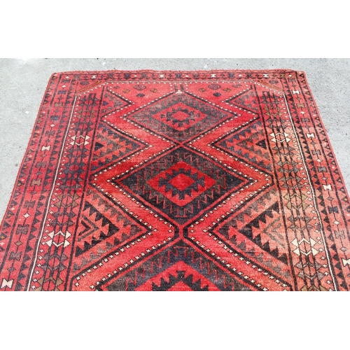 25 - Belouch rug with four centre medallions and multiple borders on a wine ground, 238 x 172cm