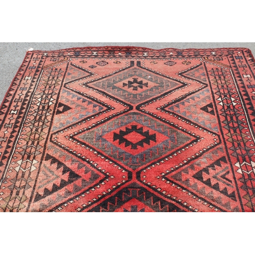 25 - Belouch rug with four centre medallions and multiple borders on a wine ground, 238 x 172cm
