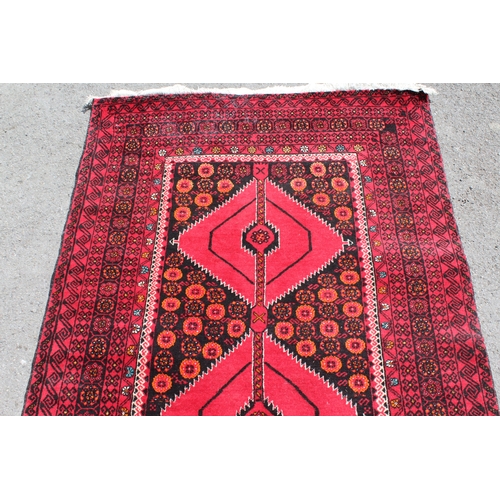 4 - Belouch rug with a triple medallion design on a dark ground with multiple borders, 210 x 108cm appro... 