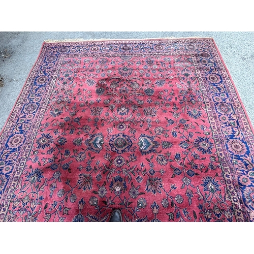 7 - Sparta carpet with an all-over stylised floral design on a pink ground with borders, 356 x 278cm