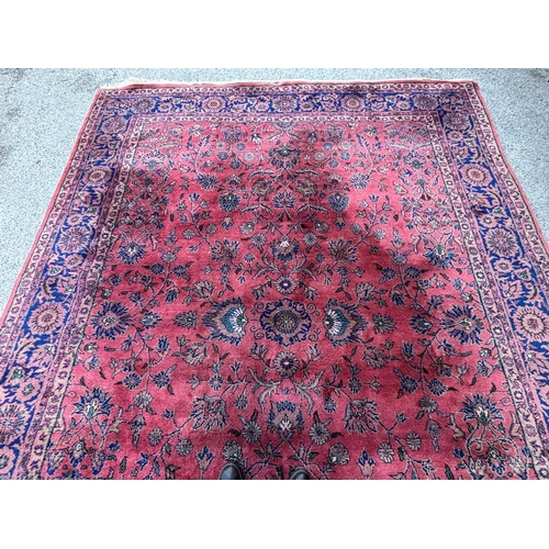 7 - Sparta carpet with an all-over stylised floral design on a pink ground with borders, 356 x 278cm