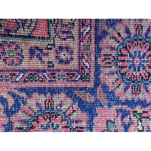 7 - Sparta carpet with an all-over stylised floral design on a pink ground with borders, 356 x 278cm