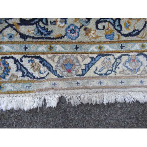 22 - Tabriz carpet of all-over floral design, with multiple borders, on a beige ground, 414cm x 286cm