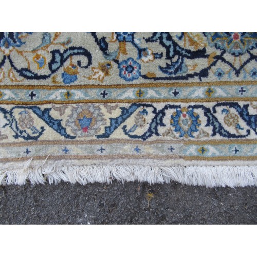 22 - Tabriz carpet of all-over floral design, with multiple borders, on a beige ground, 414cm x 286cm