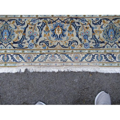 22 - Tabriz carpet of all-over floral design, with multiple borders, on a beige ground, 414cm x 286cm