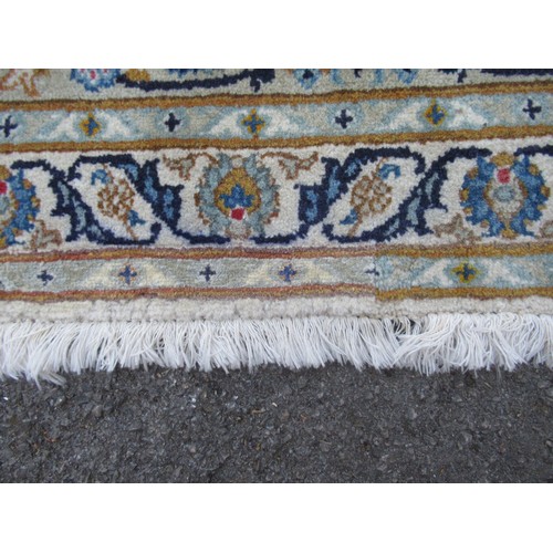 22 - Tabriz carpet of all-over floral design, with multiple borders, on a beige ground, 414cm x 286cm