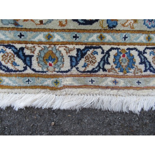 22 - Tabriz carpet of all-over floral design, with multiple borders, on a beige ground, 414cm x 286cm