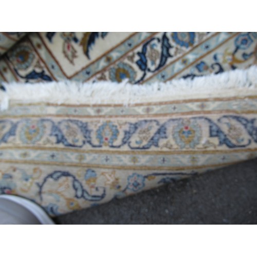 22 - Tabriz carpet of all-over floral design, with multiple borders, on a beige ground, 414cm x 286cm