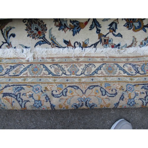 22 - Tabriz carpet of all-over floral design, with multiple borders, on a beige ground, 414cm x 286cm