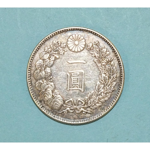 112 - A Japanese silver one Yen coin, weighs 26.8g.