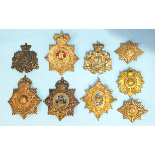 126 - A Royal Marines Gibraltar helmet plate cap badge and eight others, including Duke of Cornwall Light ... 