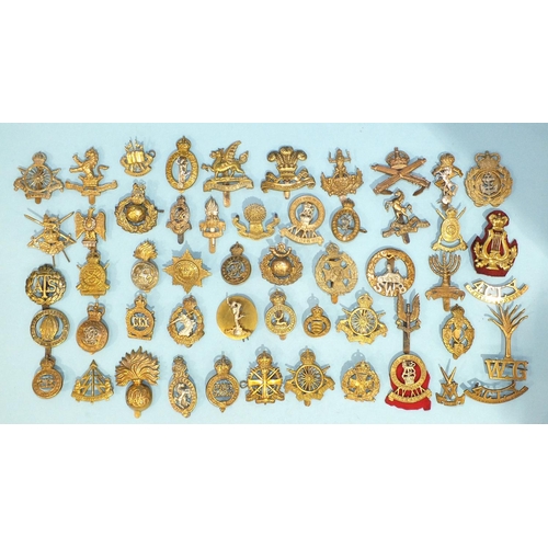 127 - A collection of fifty-two various brass military badges, (52).