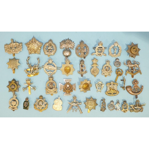 128 - A collection of thirty-five various military badges, including a silver County of London Yeomanry Sh... 