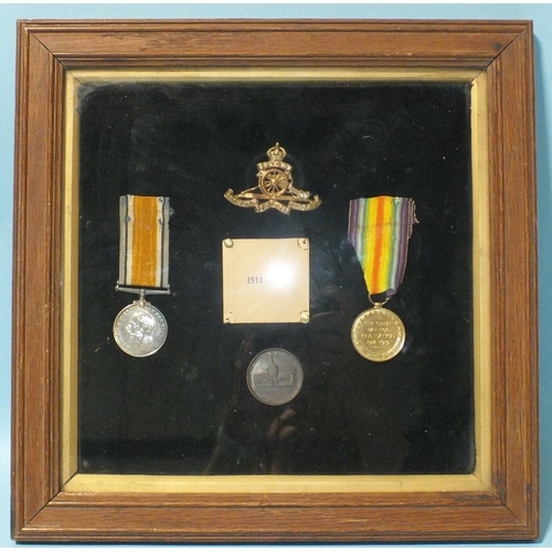 136 - A WWI pair awarded to 145313 Gnr H Mills RA: British War and Victory medals framed with a Royal Arti... 