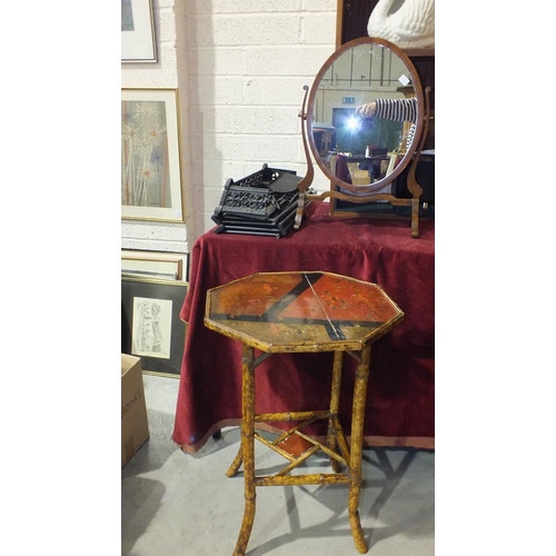 109 - A mahogany oval swing dressing table mirror, a small cast iron fender, 59cm long, a bamboo octagonal... 