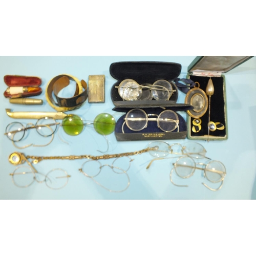 218 - A collection of vintage spectacles, a yellow metal watch chain and compass fob and other items.