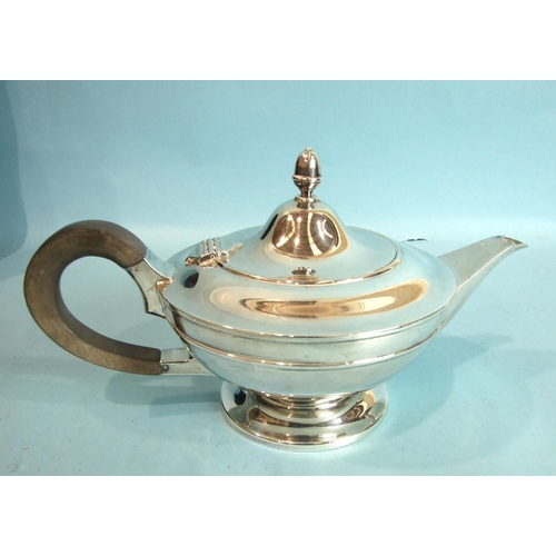 18 - A plain circular teapot of compressed form, the hinged lid with acorn finial, by Goldsmiths, Silvers... 