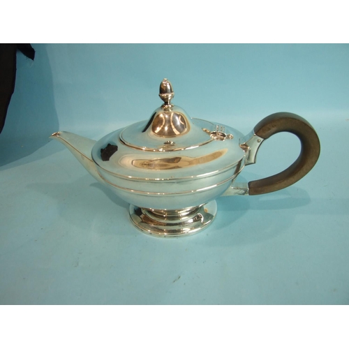 18 - A plain circular teapot of compressed form, the hinged lid with acorn finial, by Goldsmiths, Silvers... 