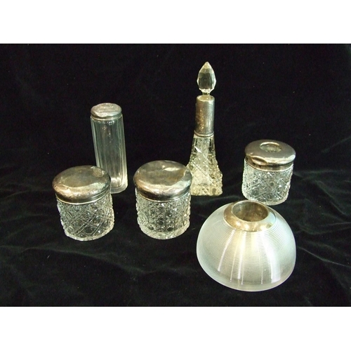 26 - A collection of silver-mounted cut-glass dressing table bottles and a silver-mounted glass match str... 