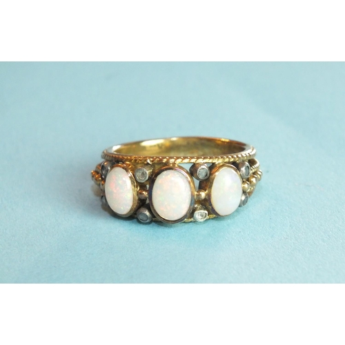 296 - An 18ct gold ring collet-set three oval opals, with rose-cut diamonds in four pairs, size R, 6.1g, b... 