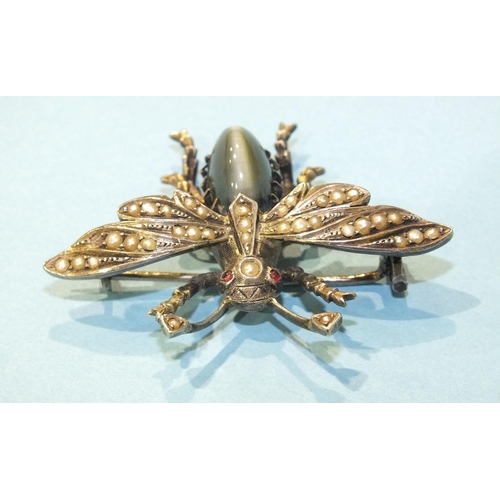 298 - A silver bee brooch claw-set a chrysoberyl cat's eye, with pearl-set wings and red paste eyes, unmar... 