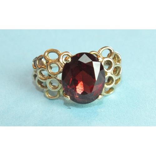 299 - A garnet-set ring with unmarked gold mount, (tests as 9ct approximately), size P, 5.4g.