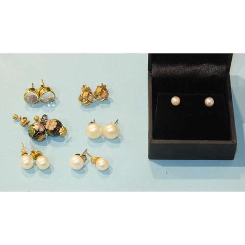 300 - A pair of unmarked ear studs set moonstones, a pair of 9ct tri-colour gold knot ear studs, four pair... 