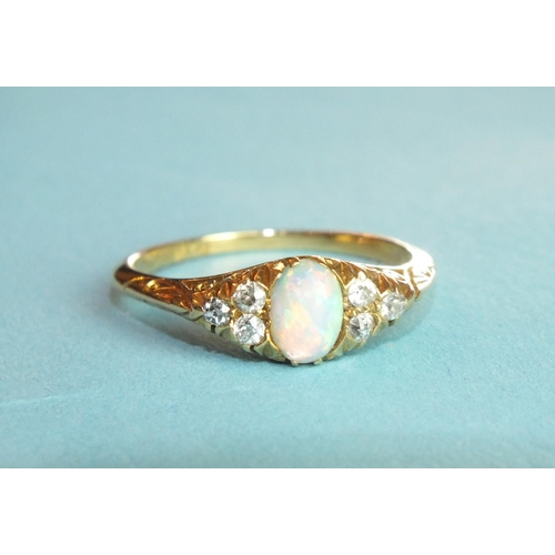 304 - An opal and diamond ring set an opal between triplets of diamond points, in 18ct gold mount, size P,... 