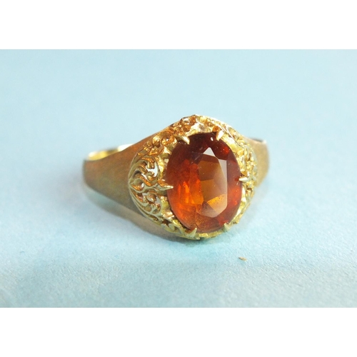 310 - A citrine-set ring with pierced mount, on textured shank, unmarked, tests as 18ct gold approximately... 