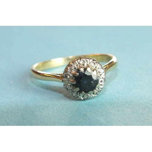 314 - An 18ct gold sapphire and diamond cluster ring set a round-cut sapphire and ten 8/8-cut diamonds, si... 