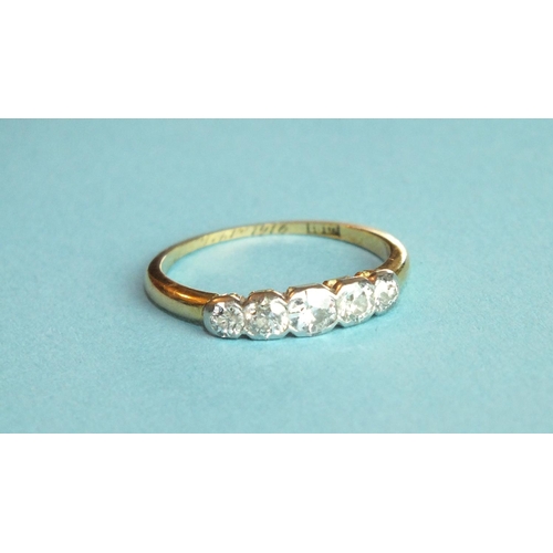 328 - A five-stone diamond ring, the graduated old-cut diamonds in rubbed-over settings, on 18ct gold moun... 