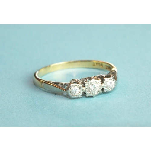 331 - A three-stone diamond ring in 18ct gold and platinum mount, size L, 2g.