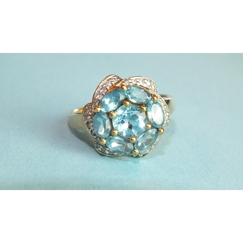 344 - A blue topaz and diamond cluster ring with 9ct gold mount, size O, 3.9g.