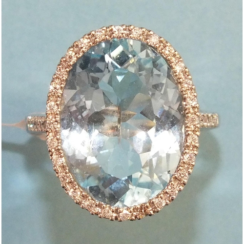 354 - A blue topaz and diamond ring, the oval blue topaz of approximately 13.2cts, within a surround of tw... 