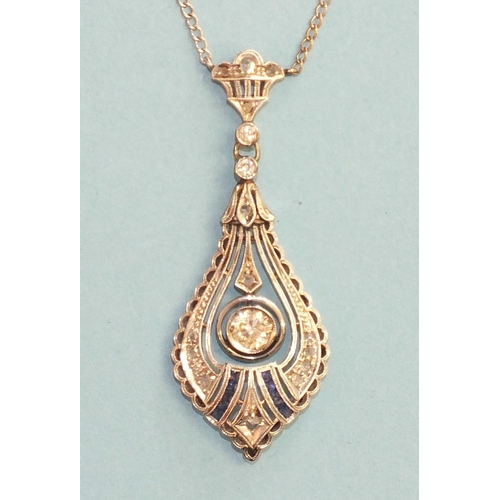 357 - An Art Deco diamond and sapphire 18ct white gold pendant on chain, having a central drop collet-set ... 