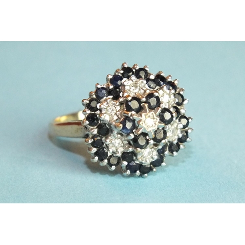 363 - A sapphire and diamond flower head cluster ring set round-cut sapphires and 8/8-cut diamonds, in 9ct... 