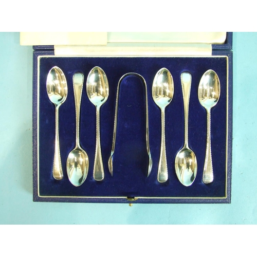 47 - A set of six feather-edge teaspoons and matching sugar tongs, in case, by Goldsmiths, Silversmiths C... 