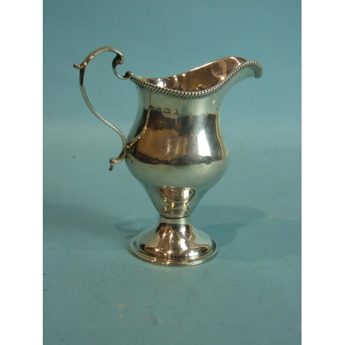 75 - A helmet-shaped cream jug with beaded rim and circular foot, 12cm high, Birmingham 1901, ___3oz.