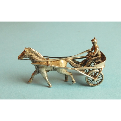 88 - A silver miniature model of a jockey harness racing, 51mm long, marked Silver 900.