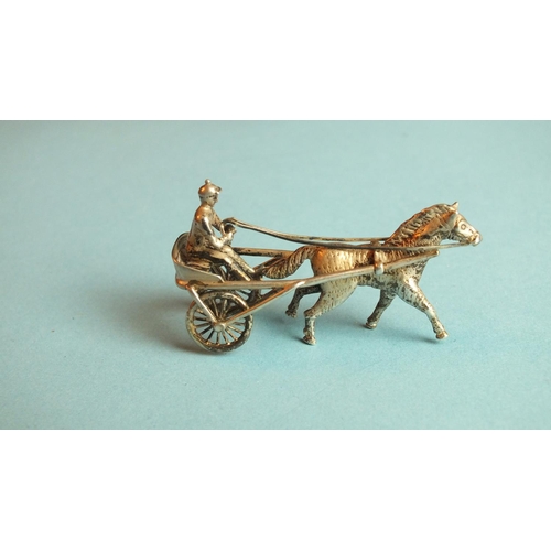 88 - A silver miniature model of a jockey harness racing, 51mm long, marked Silver 900.