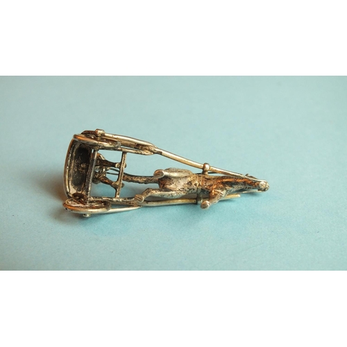 88 - A silver miniature model of a jockey harness racing, 51mm long, marked Silver 900.