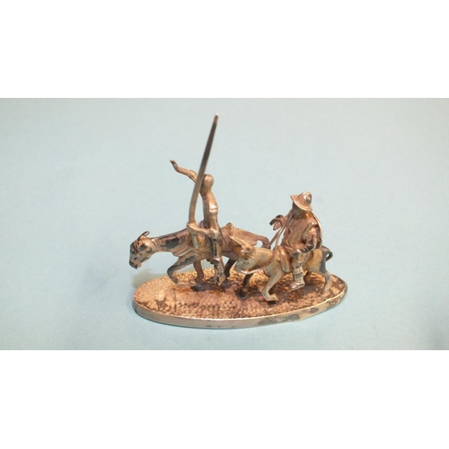 89 - A silver miniature model of Don Quixote and Sancho Panza, on oval base, 51mm long, marked 900 silver... 