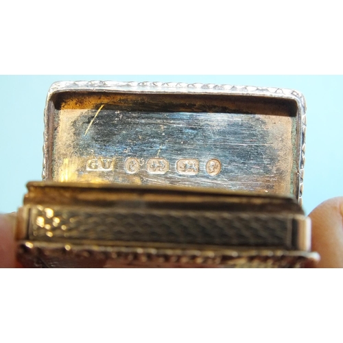 92 - A Victorian silver rectangular vinaigrette by George Unite, the scroll-moulded rim around an engine-... 