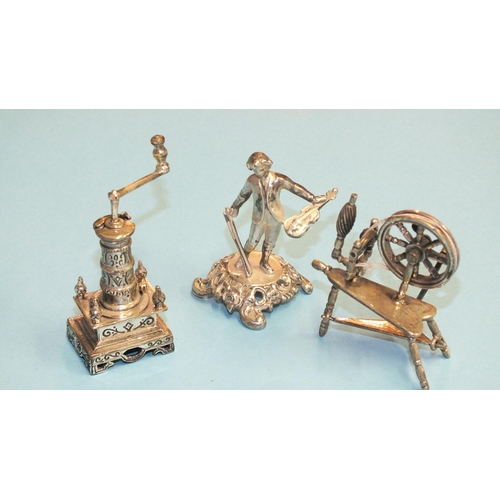 96 - A silver miniature model of a coffee grinder, 65mm high, a silver miniature spinning wheel, 52mm hig... 