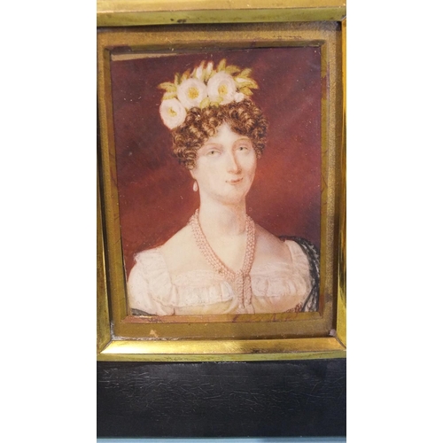 569 - An early 19th century miniature portrait of a lady with a pearl necklace and flowers in her hair, 7.... 