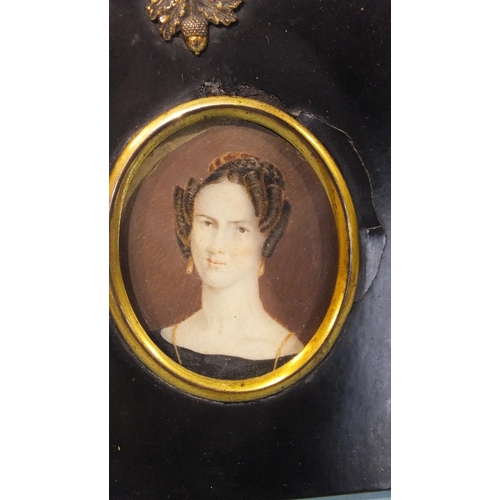 569 - An early 19th century miniature portrait of a lady with a pearl necklace and flowers in her hair, 7.... 