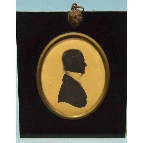 610 - John Field, an oval painted silhouette of a gentleman wearing a white stock, signed Field, 2 Strand,... 